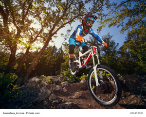 Cyclist riding a mountain bike downhill style. Extreme sports on a bicycle outdoors.